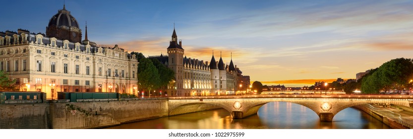 Consiergerie, Pont Neuf and Seine river with tour boat at sunny summer sunset, Paris, France