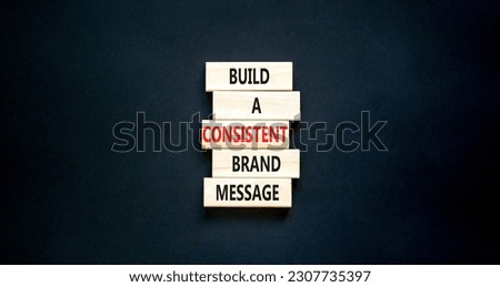 Consistent brand message symbol. Concept words build a consistent brand message on wooden blocks. Beautiful black table black background. Business consistent brand message concept. Copy space.