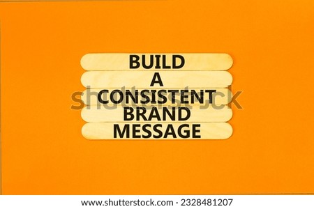 Consistent brand message symbol. Concept words build a consistent brand message on wooden stick. Beautiful orange table orange background. Business consistent brand message concept. Copy space.