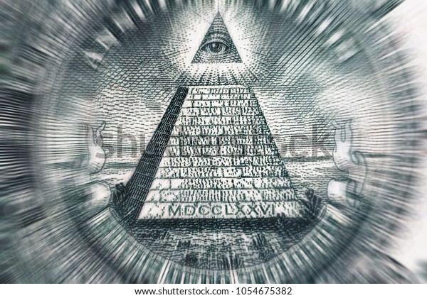 Conspiracy theory\
concept. All Seeing Eye and Pyramid on USA dollar banknote, macro\
photo with motion blur effect\
