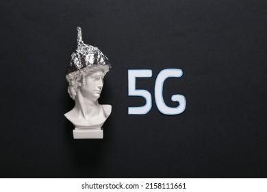 Conspiracy Theory. David Bust In Foil Hat And Word 5G On A Black Background