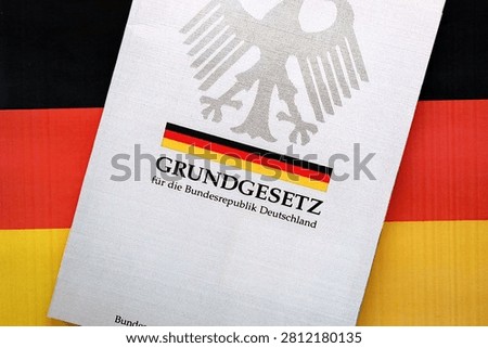 The constitution basic law book of Germany lies on Germany flag background close up