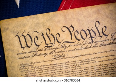 The constitution of the United States of American with a vintage flag - Shutterstock ID 310783064