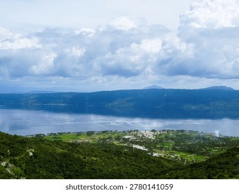 constrasting with cloud shadows and dense distant forests