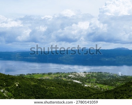 constrasting with cloud shadows and dense distant forests
