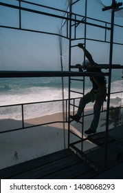 constroction site worker in front the beach