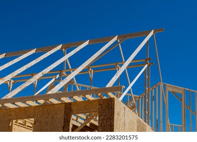 An construct wooden roof beam from framework of trusses frames for newly constructed stick house