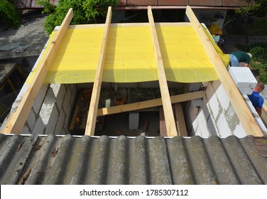 Constructing Roof With Trusses, Roof Beams, Vapor Barrier Of Home Addition, Home Extension From Autoclaved Aerated Concrete Blocks Of The House With Asbestos Roof. 