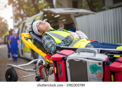 The construction accident : Male patient unconscious  broken head Lying in an ambulance stretcher to transport the wounded to the hospital by an ambulance. Accident at work construction. - Powered by Shutterstock