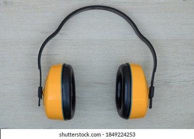 Construction, anti-noise headphones. Background with yellow headphones.