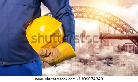 Construction 
architect or engineer or worker or foreman holding safety yellow  helmet(hard hat) and 
 
