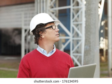 Construction architect working on laptop at construction site. - Shutterstock ID 176134595