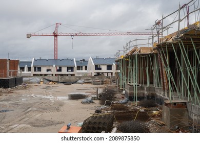 Construction Area. Buildings Half Built And A Crane In The Background