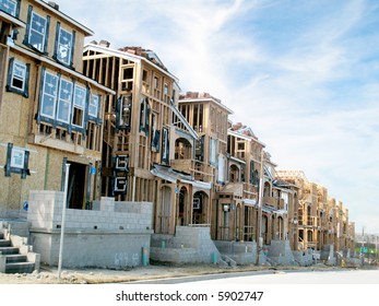 Construction area, row of new homes being built in nice suburban area.