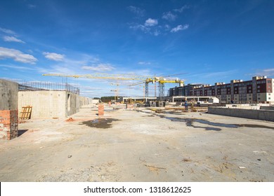 

Construction area with yellow cranes at summer time.  