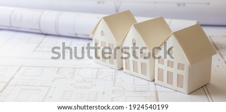 Construction blueprints concept. Residence complex architectural drawings and detached houses models, Architect engineer work space, office desk.