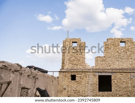 Construction of a building in Asia using bricks of various colors