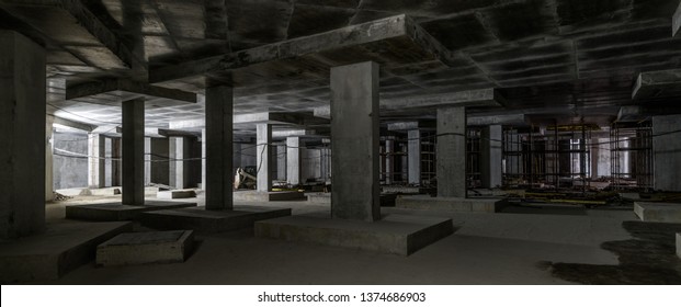 Construction building basement  panorama inside dark construction site  Commercial structure under construction and concrete walls   floor  Concept factory  parking  underground   industry