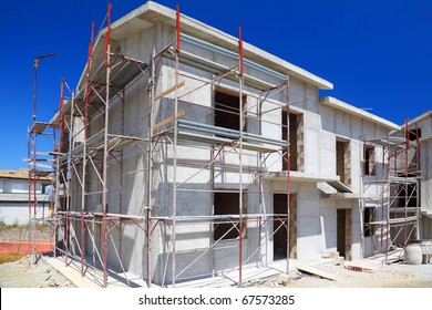 Construction Of Building Of New Two-story White Concrete House With Stairs And Balcony