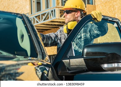 Construction Business Owner. Caucasian Supervisor In His 30s Wearing Yellow Hard Hat And His Company Pickup Truck.