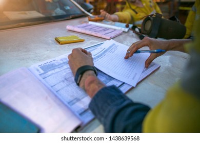 Construction coal miner supervisor conducting safety checking on job hazards analysis on hot work permit before sign off approval to work on  open field construction coal mine site Sydney, Australia 