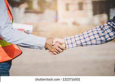 Construction Company Handshaking With Material Supplier.