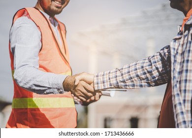 Construction Company Handshaking With Material Supplier.