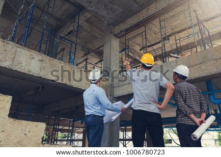 Construction concept of Engineer and Architect working at Construction Site with blue print
