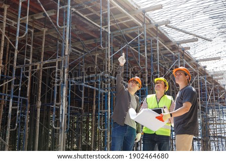 Construction concept of Engineer and Architect working at Construction Site with blue print