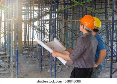 Construction concepts, Engineer and Architect working at Construction Site with blueprint