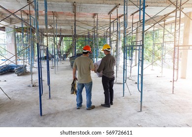 Construction concepts, Engineer and Architect working at Construction Site with blueprint