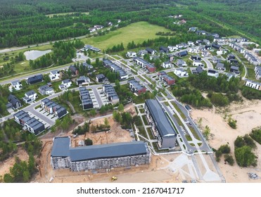 Construction of Cottage, townhouse and line house. Townhouses and suburd two-floor home construction. Suburb houses and modern residential buildings. Roofs of suburban private houses in forest area. 
				