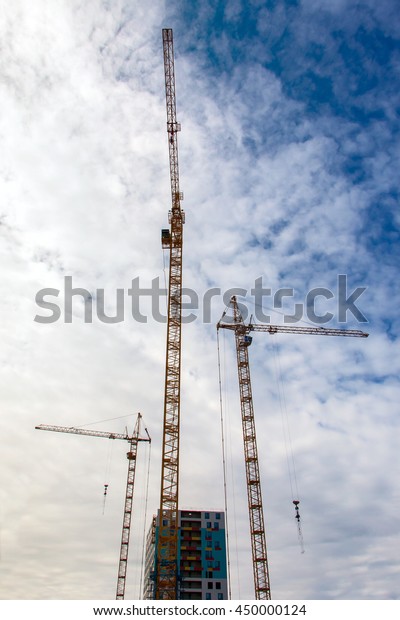 construction crane\
building a house and\
skyscraper