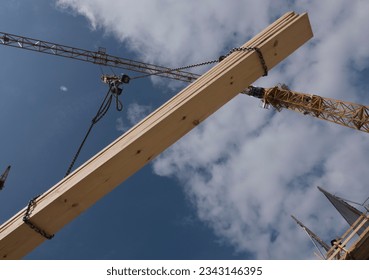 Construction crane with heavy load, at construction site