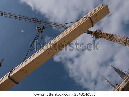 Construction crane with heavy load, at construction site