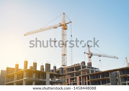 Construction crane on the background of the sky. Construction site.