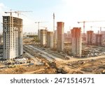 Construction crane on Housing. Construction site with buildings under construction. Tower cranes in action. Crane during formworks. Multi Storey Residential Buildings construction, aerial view.