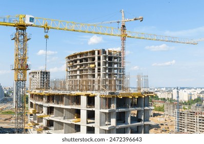 Construction crane on Housing. Construction site with buildings under construction. Tower cranes in action. Crane during formworks. Multi Storey Residential Buildings construction, aerial view.