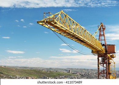 Construction crane tower against a blue sky