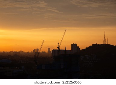 Construction cranes against the evening sky - Powered by Shutterstock