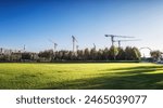 Construction Cranes Over Urban Development Park Area