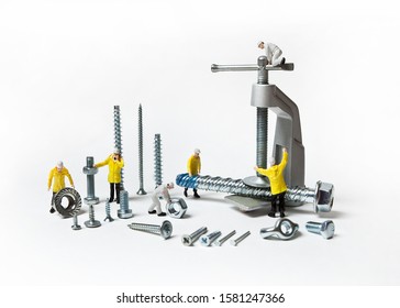 Construction Crew With Mounting Material Of Different Calibers On A White Background. People Are Dolls.