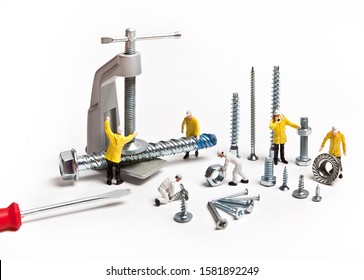 Construction Crew With Mounting Material Of Different Calibers On A White Background. People Are Dolls.