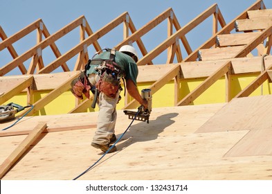 Construction Crew Working On The Roof Sheeting Of A New, Two Story, Commercial Apartment Building In Oregon