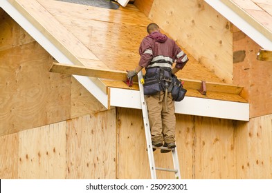 Construction Crew Working On The Roof Sheeting Of A New, Luxury Residential Home Project In Oregon