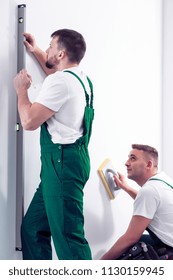 Construction Crew Working Together Using A Plastering Trowel And Contour