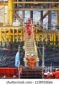 Construction Crews Cross Gang Way From Accommodation Vessel To Static Platform.