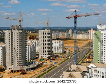 Construction crews work on multiple high-rise residential buildings in a growing city, showing cranes and bustling activity.