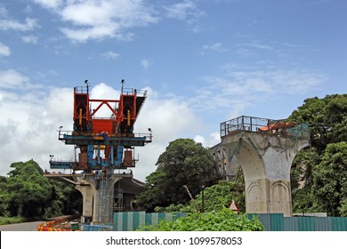 Construction Of Deck Of Elevated Road By Joining Together Precast Segments Made Of Concrete Over Columns Using Huge Launching Girder, Part Of Third Bridge Across Mandovi River In Goa, India