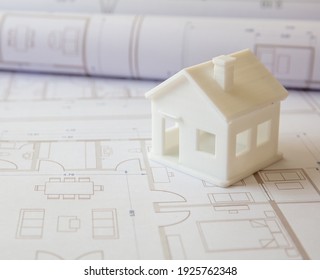 Construction design blueprints concept. Housing project drawings and architectural house model on an office desk. Architect engineer work space - Powered by Shutterstock